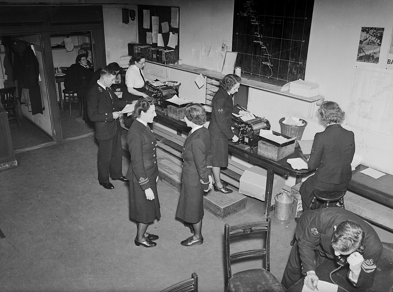 Coast Guard memorabilia from WWII era displaying women's service insignia and badges, related to auxiliary territorial forces