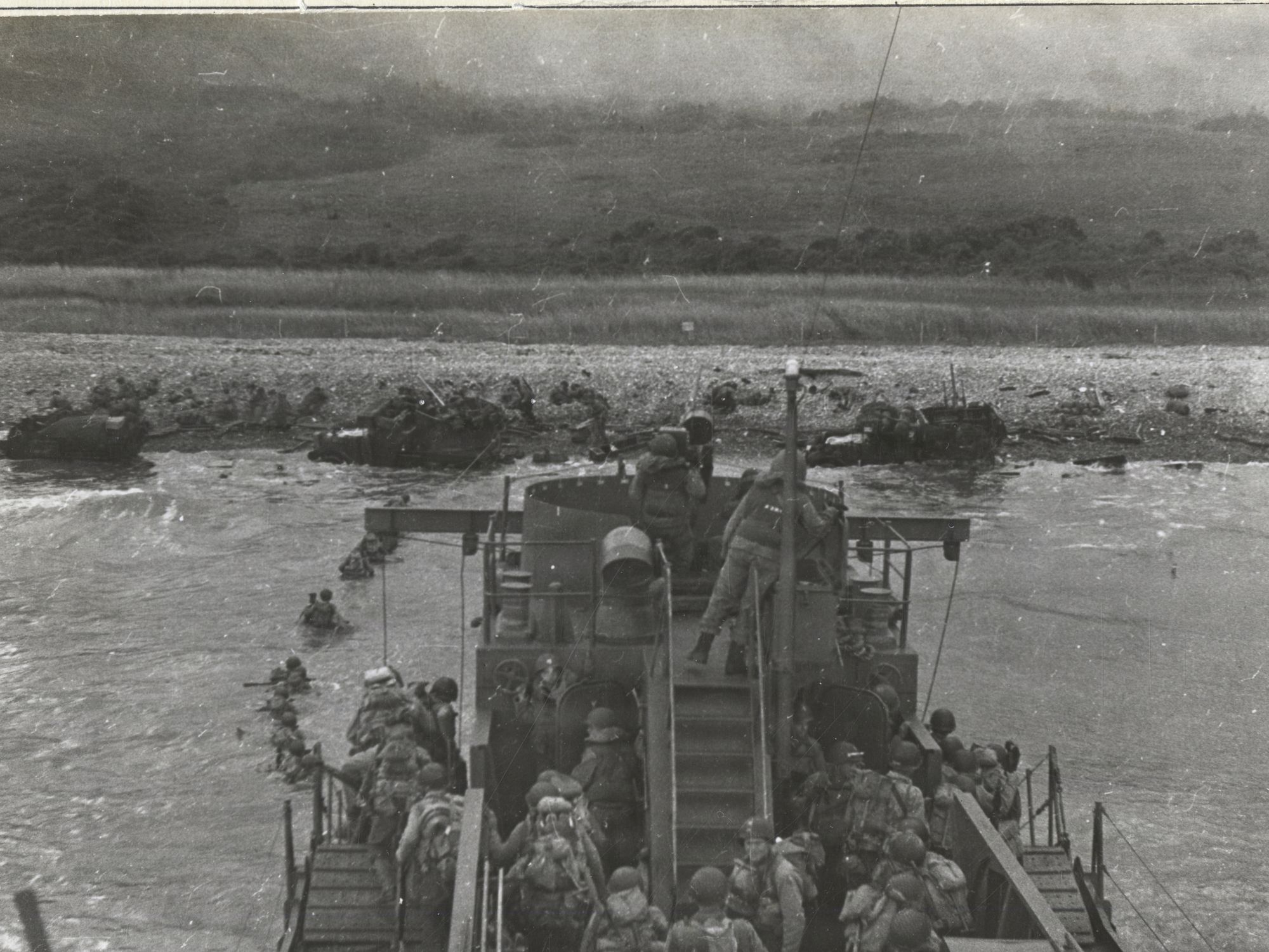 US Army Infantry Disembark From Bow of USS LCI(L) 412 at Omaha Beach, Normandy, France on D-Day