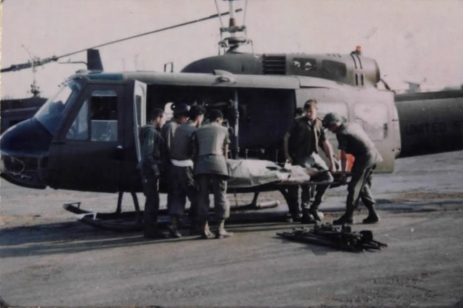 A Vietnamese wounded in the Tet Offensive attack on Tan Son Nhut Air Base is loaded onto a UH-1E.jpg