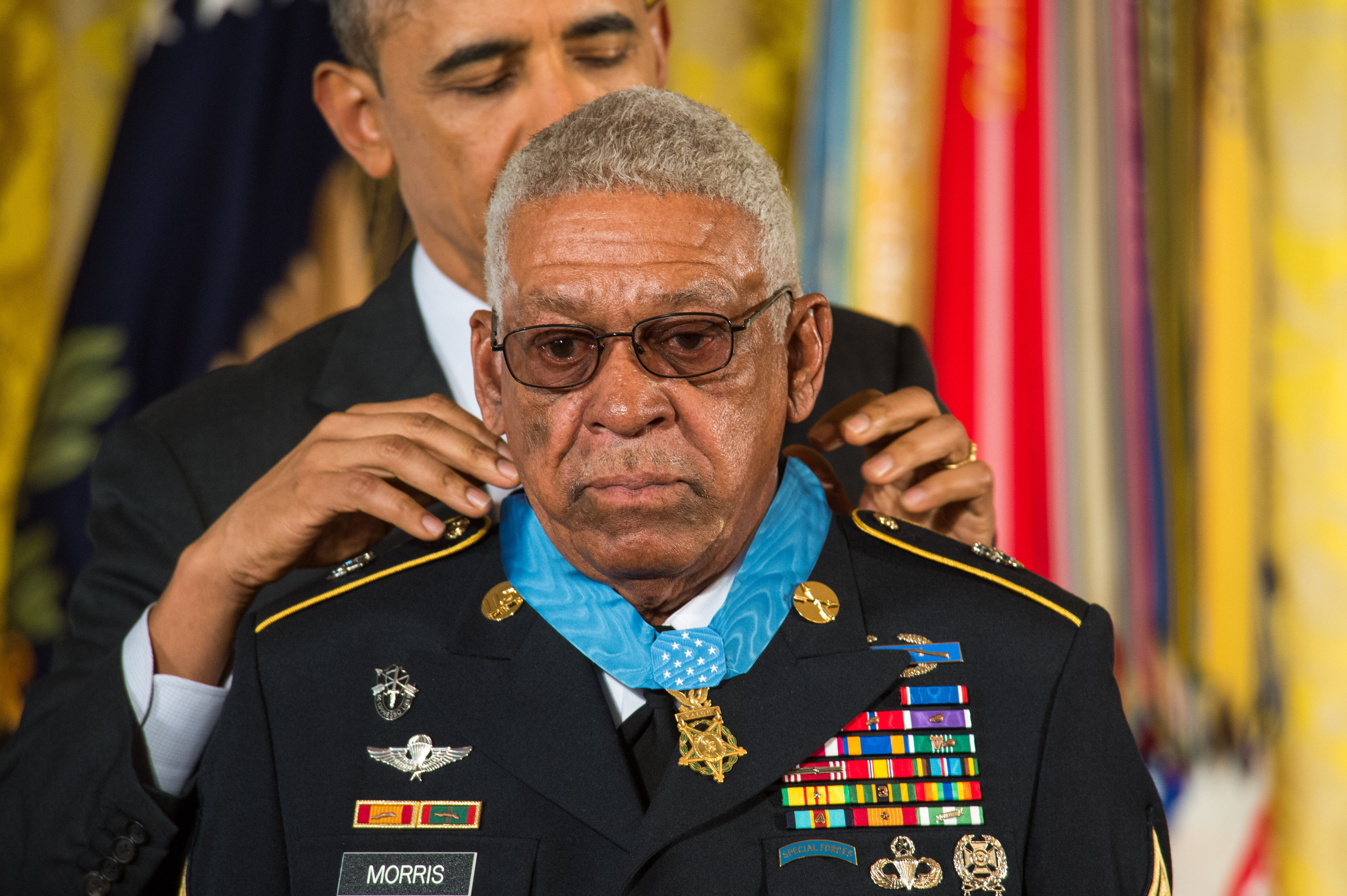 President Barack H. Obama, background, presents a Medal of Honor to former U.S. Army Sgt. 1st Class