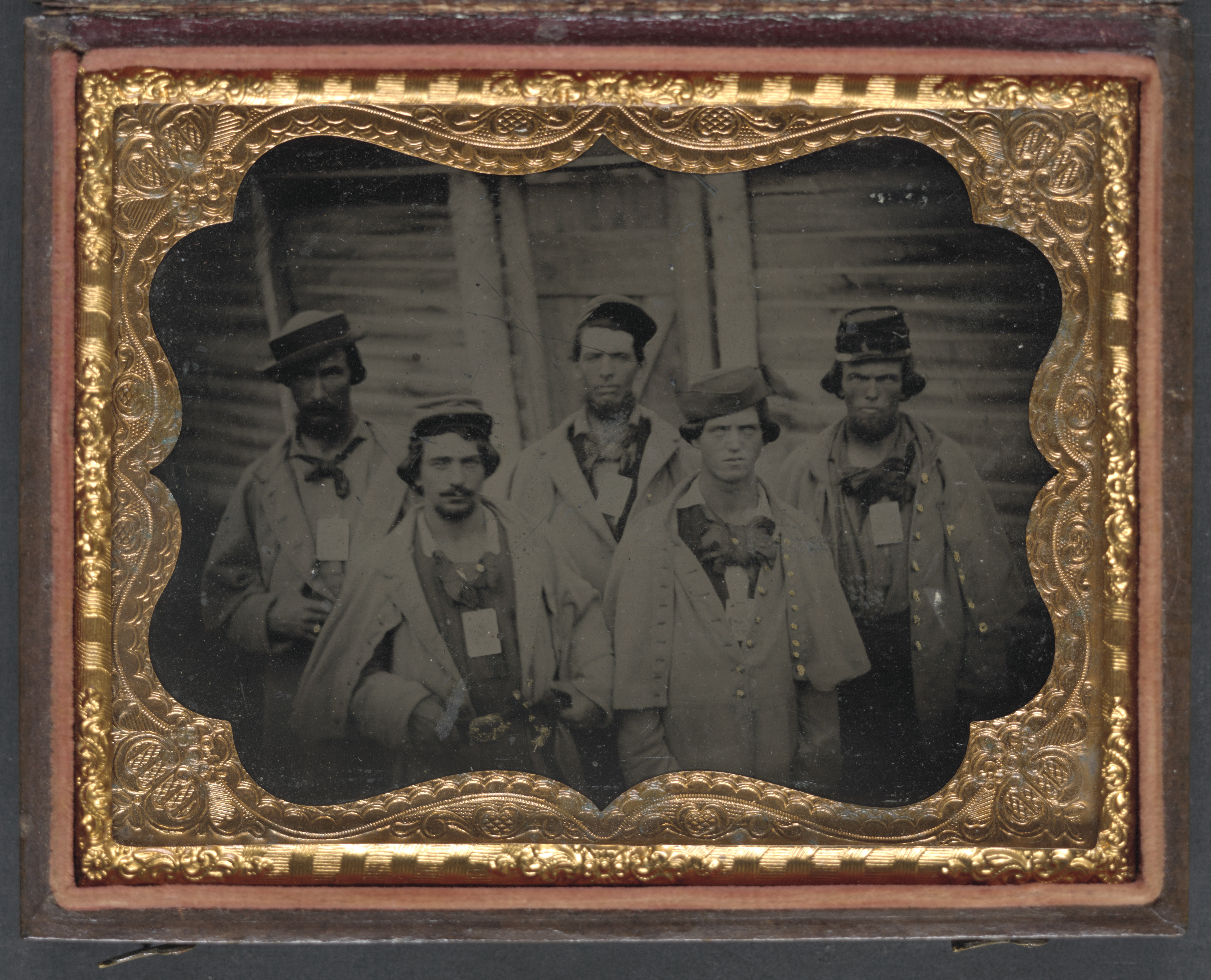 Five unidentified prisoners of war in Confederate uniforms in front of their barracks at Camp Douglas Prison, Chicago, I